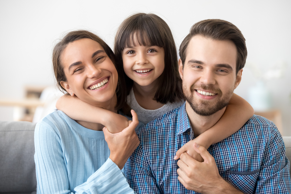 Family picture sitting on the couch - Teeth Whitening in Seattle