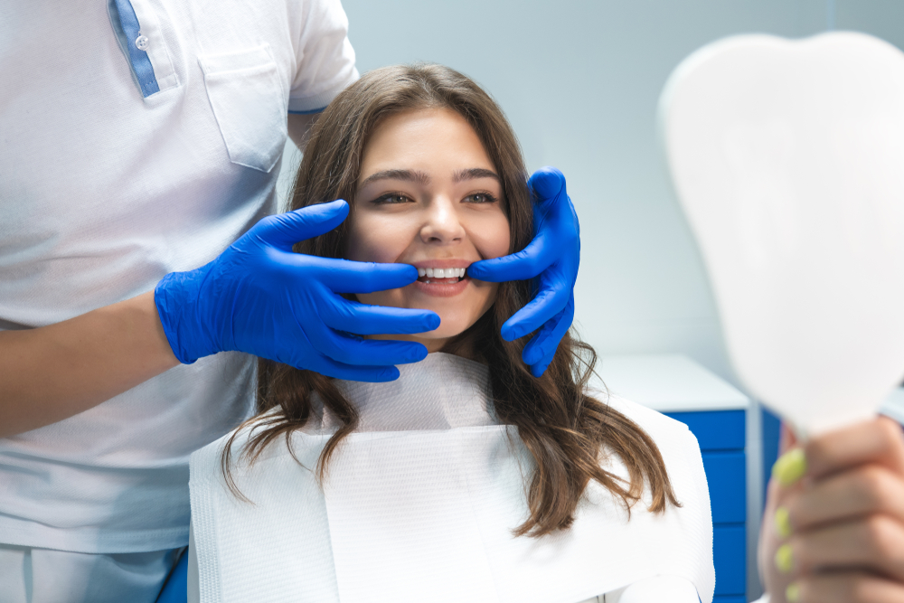 Dentist checking teeth of patient - Dental Crown in Seattle